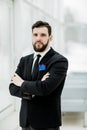 Successful businessman standing near a window in bright office. Royalty Free Stock Photo