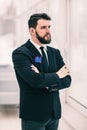 Successful businessman standing near a window in bright office. Royalty Free Stock Photo