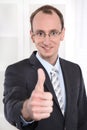 Successful businessman with suit and tie smiling and thumbs up a Royalty Free Stock Photo