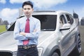 Successful businessman taking photo in front of luxurious car Royalty Free Stock Photo