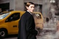 Successful businessman walking on New York City street at daytime to work wearing black elegant jacket. Royalty Free Stock Photo