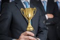 Successful businessman was awarded with trophy for excelent skills Royalty Free Stock Photo