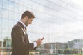 Successful businessman or worker standing in suit with cellphone Royalty Free Stock Photo