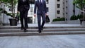 Successful businessmen walking downstairs near office building, leaving meeting