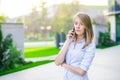 Successful businesswoman or entrepreneur talking on cellphone while walking outdoor Royalty Free Stock Photo