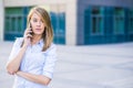 Successful businesswoman or entrepreneur talking on cellphone while walking outdoor Royalty Free Stock Photo