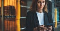 Successful businesswoman hold in hands smartphone during a lunch break outside office, Manager uses mobile phone in city outdoors Royalty Free Stock Photo