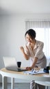 Successful businesswoman raised hands up celebrating business success .