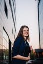 Successful businesswoman stands on the background of buildings and holding tablet computer. City business woman working. Royalty Free Stock Photo