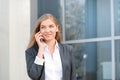 Successful businesswoman talking on cellphone while walking outdoor Royalty Free Stock Photo