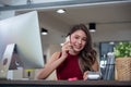 Successful businesswoman working at the office, Attractive young woman talking on the mobile phone