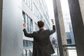 Successful Caucasian businessman with arms up celebrating victory. Concept: success, career growth, victory, freedom. silhouette