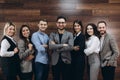 Successful company with happy workers standing in row in modern office