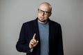 Successful confident businessman in glasses speaking over beige background.