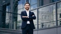 Successful confident caucasian bearded businessman in suit standing outdoors on background office building smiling proud Royalty Free Stock Photo