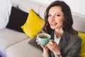 Successful confident middle aged female teacher having cup of coffee before online lesson, sitting in front of laptop, using Royalty Free Stock Photo