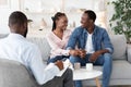 Successful Couples Therapy. Reconciled black spouses embracing at therapist office Royalty Free Stock Photo