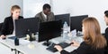 Successful coworkers engaged in business activities in busy open plan office