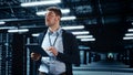 Successful Data Center IT Specialist Using Tablet Computer. Server Farm Cloud Computing Facility