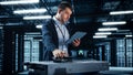 Successful Data Center IT Specialist Using Tablet Computer. Server Farm Cloud Computing Facility