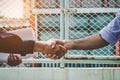 Successful deal architect shaking hands with client in construction site after confirm blueprint for renovate building Royalty Free Stock Photo