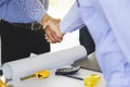Successful deal, Female architect shaking hands with client in construction site. Royalty Free Stock Photo