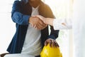 Successful deal, male architect shaking hands with client in construction site after confirm blueprint for renovate building Royalty Free Stock Photo