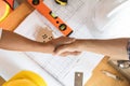 Successful deal, male architect shaking hands with client in construction site after confirm blueprint for renovate building Royalty Free Stock Photo