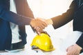 Successful deal, male architect shaking hands with client in construction site. Royalty Free Stock Photo