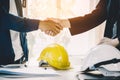 Successful deal, male architect shaking hands with client in construction site. Royalty Free Stock Photo