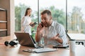 Successful deal. Using laptop. Man and woman are working in the modern office together Royalty Free Stock Photo