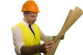 Successful engineer in hardhat and vest - young efficient and attractive builder or contractor holding looking to blueprints