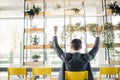 Successful excited business man happy smile hold fist gesture view from back, handsome young businessman with raised hands arms. Royalty Free Stock Photo