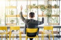 Successful excited business man happy smile hold fist gesture view from back, handsome young businessman with raised hands arms. Royalty Free Stock Photo