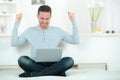 successful excited business man with laptop