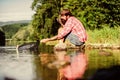 successful fisherman in lake water. big game fishing. relax on nature. hipster fishing with spoon-bait. mature bearded Royalty Free Stock Photo