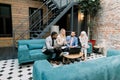 Successful four young international business people working together in office. Caucasian lady brainstorming with their Royalty Free Stock Photo