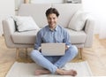 Successful Freelancer Working On Laptop Sitting On Floor At Home Royalty Free Stock Photo