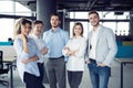 Successful friendly team with happy workers in office. Royalty Free Stock Photo