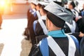 Successful graduates in academic dresses, at graduation, sitting Royalty Free Stock Photo