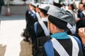 Successful graduates in academic dresses, at graduation, sitting Royalty Free Stock Photo