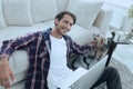 Successful guy stroking his pet sitting on the floor near the sofa Royalty Free Stock Photo