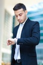 Successful handsome businessman looking at his watch Royalty Free Stock Photo