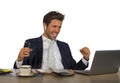 Successful handsome businessman in suit working at office computer desk celebrating financial success winning money smiling cheerf Royalty Free Stock Photo