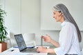 Successful happy Asian businesswoman having corporate video chat in office. Royalty Free Stock Photo