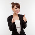 Successful happy Asian businesswoman showing thumb