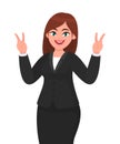 Successful happy businesswoman showing / gesturing V or victory sign. Businesswoman showing two fingers. Royalty Free Stock Photo