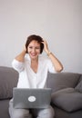 successful happy confident brunette woman 35-40 years old sits on the couch and works using a laptop Royalty Free Stock Photo