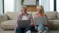 Successful happy mature caucasian married couple man woman entrepreneurs grandfather grandmother using laptops computer Royalty Free Stock Photo