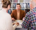 Successful seller and buyers at table in office